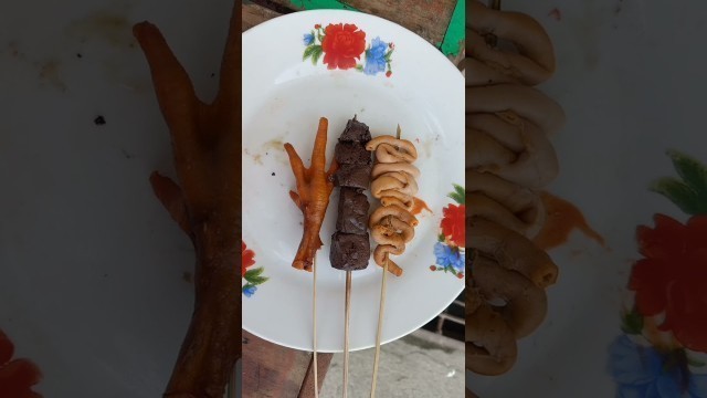 'amazing street food: chicken feet , betamax, isaw chicken'