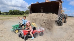 'Using kids tractors and real tractors to dig dirt | Playing in dirt and water | Tractors for kids'