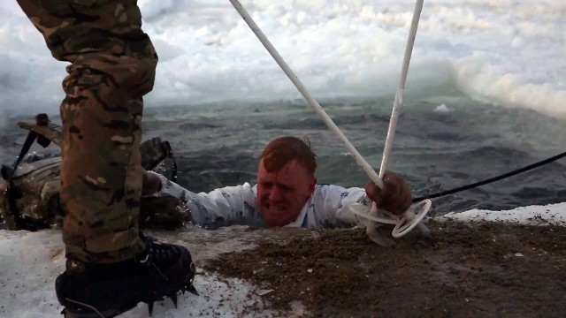 'British Royal Marines Commandos train US Marines to survive in freezing water.'